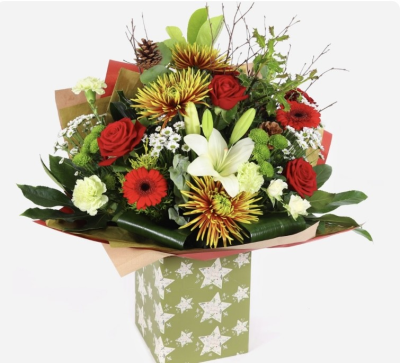 Christmas Hand tied - A hand tied Christmas bouquet of reds, whites, greens & golds. Presented in a gift box of water.