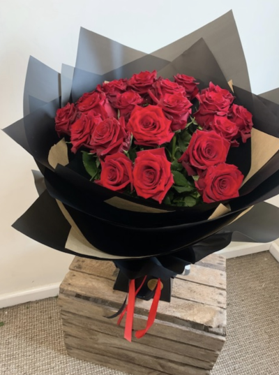 Lux 20 Rose Bouquet - A luxury hand tied bouquet of 20 long stem large red roses. Presented in dramatic black wraps and a black box.