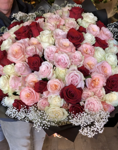 Lux 100 Rose Bouquet - A hand tied bouquet of long stem, large mixed roses surrounded with delicate gypsophilia. Beautifully wrapped. Made in our Chester flower shop and delivered with care.